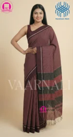 Woman wearing traditional chocolate Patteda Anchu saree with maroon stripes for festive occasion