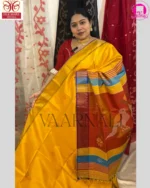Traditional red border work on yellow Bishnupuri Kalakshetra saree featuring temple motifs and handloom weaving texture