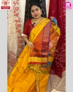 Indian model wearing yellow red Kalakshetra saree with gold jewelry in Bengali draping style for festive celebration
